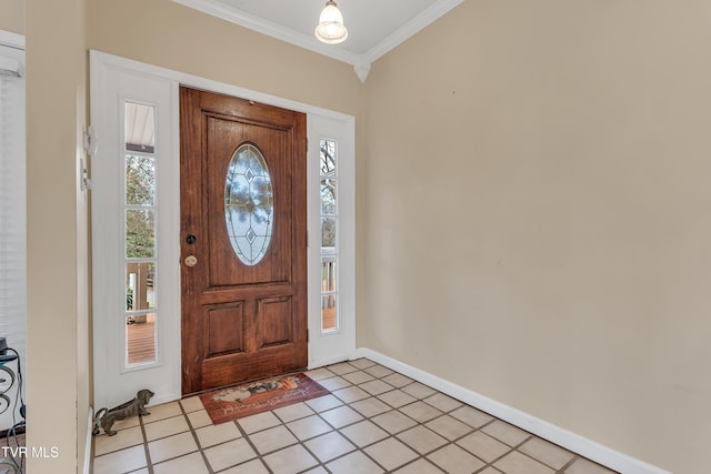 entrance foyer with ornamental molding and light tile patterned floors