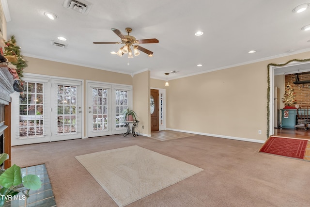 carpeted living room featuring ceiling fan and ornamental molding