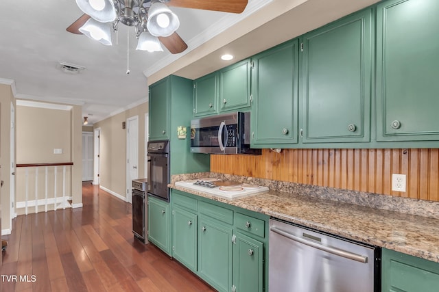 kitchen with appliances with stainless steel finishes, dark hardwood / wood-style floors, crown molding, and green cabinets