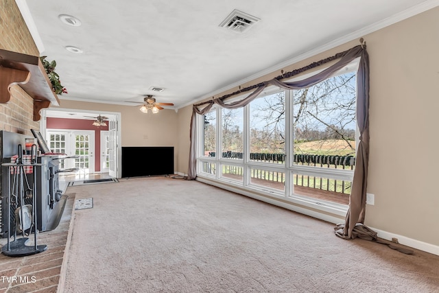 unfurnished living room featuring plenty of natural light, ceiling fan, carpet floors, and ornamental molding