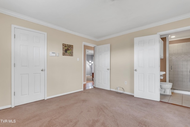 unfurnished bedroom featuring carpet flooring, ensuite bath, and ornamental molding