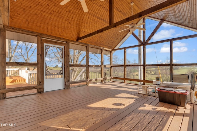 unfurnished sunroom featuring vaulted ceiling with beams and ceiling fan