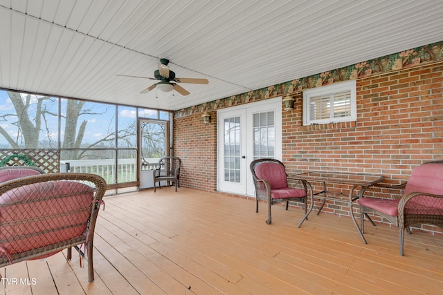 sunroom / solarium featuring french doors, ceiling fan, and wood ceiling