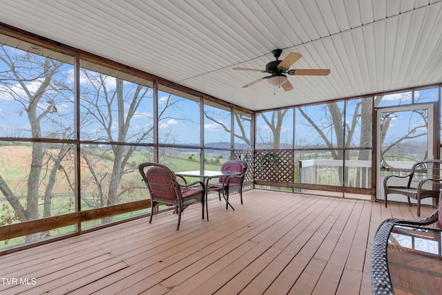 unfurnished sunroom featuring ceiling fan