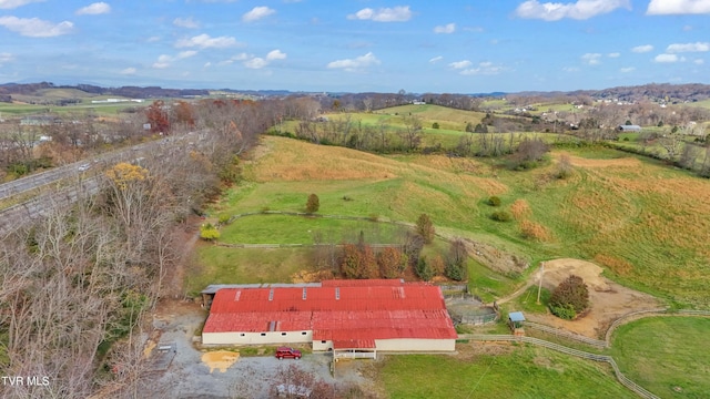 birds eye view of property with a rural view