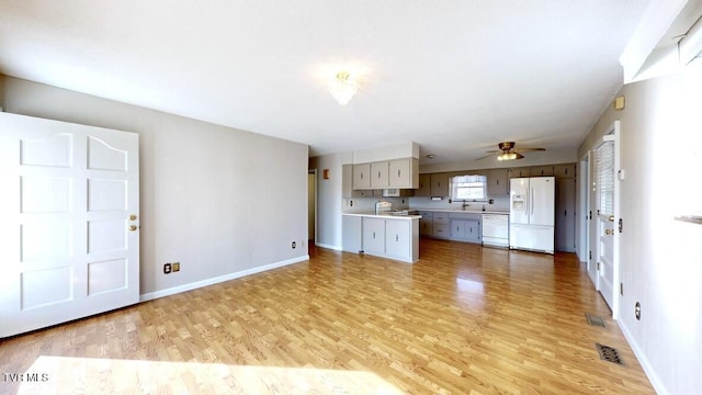 kitchen with white appliances and light hardwood / wood-style flooring