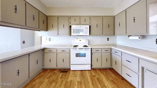 kitchen with sink, light hardwood / wood-style floors, and white appliances