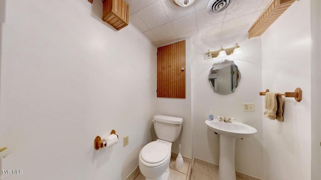 bathroom with tile patterned flooring, toilet, and sink