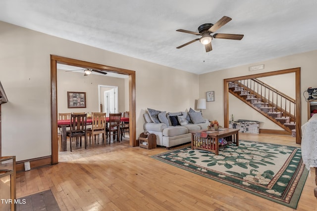 106 W Sycamore Ave, Big Stone Gap, VA 24219 - living area featuring a ceiling fan, light wood-style flooring, and stairs