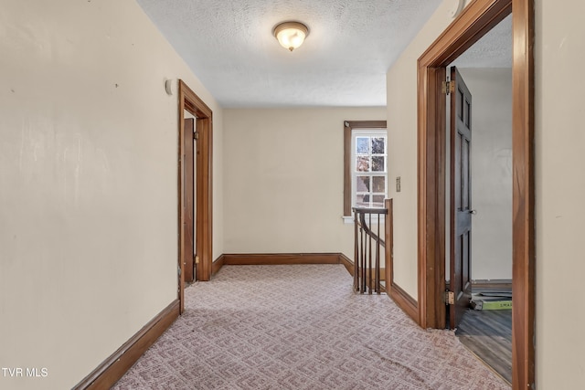 106 W Sycamore Ave, Big Stone Gap, VA 24219 - corridor featuring a textured ceiling, baseboards, carpet flooring, and an upstairs landing