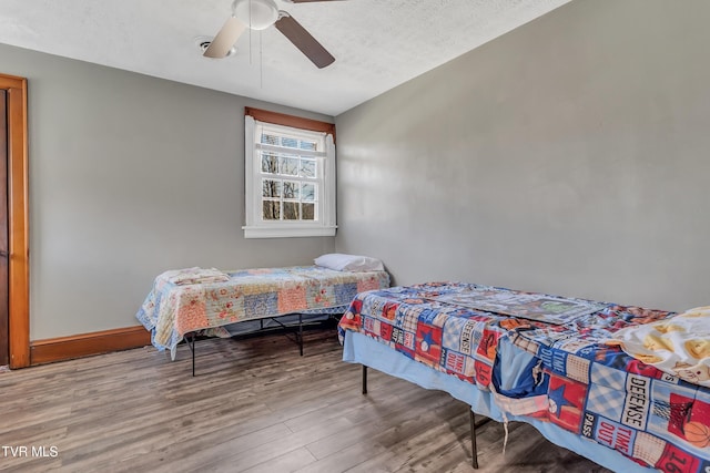 106 W Sycamore Ave, Big Stone Gap, VA 24219 - bedroom featuring wood finished floors, a ceiling fan, and baseboards