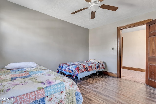 106 W Sycamore Ave, Big Stone Gap, VA 24219 - bedroom with wood finished floors, baseboards, a textured ceiling, and a ceiling fan