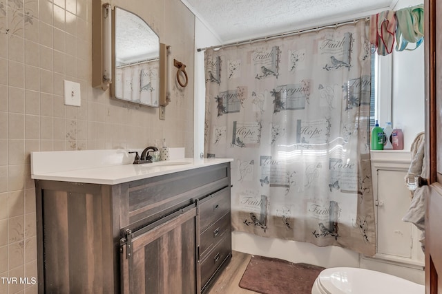 106 W Sycamore Ave, Big Stone Gap, VA 24219 - full bath featuring vanity, a textured ceiling, shower / bath combo with shower curtain, tile walls, and toilet