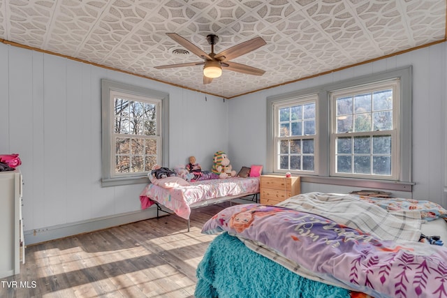 106 W Sycamore Ave, Big Stone Gap, VA 24219 - bedroom featuring crown molding, an ornate ceiling, multiple windows, hardwood / wood-style floors, and a ceiling fan