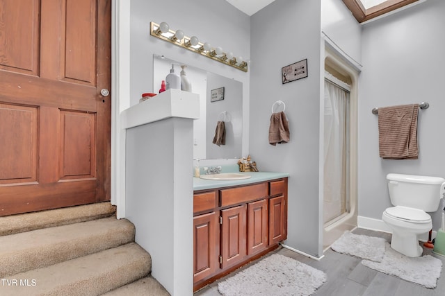 106 W Sycamore Ave, Big Stone Gap, VA 24219 - bathroom with vanity, toilet, a shower stall, baseboards, and wood finished floors