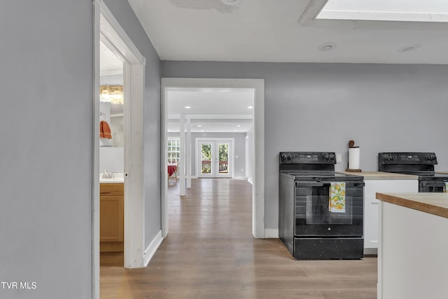 106 W Sycamore Ave, Big Stone Gap, VA 24219 - kitchen featuring black electric range, light wood-style floors, a sink, and recessed lighting