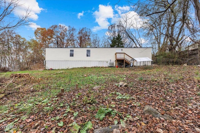 rear view of property with central AC unit