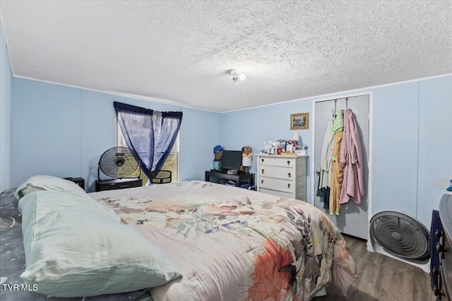 bedroom featuring wood-type flooring and a textured ceiling