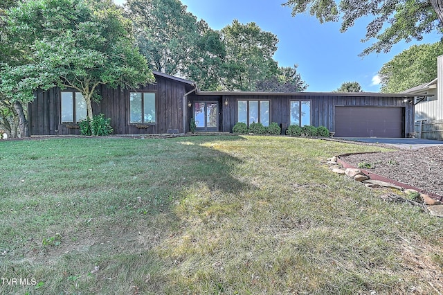 ranch-style home with a front yard and a garage