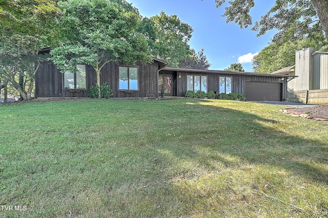 view of front of home with a front lawn and a garage