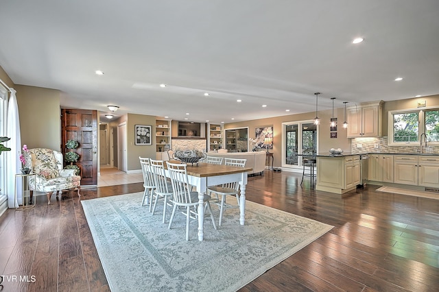 dining room with dark hardwood / wood-style floors and sink