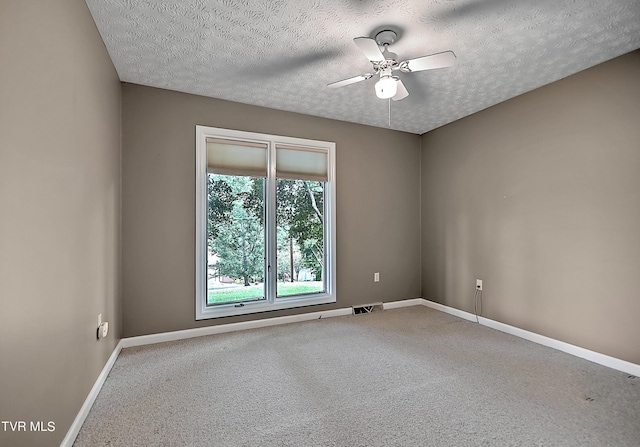 empty room featuring carpet flooring, a textured ceiling, and ceiling fan