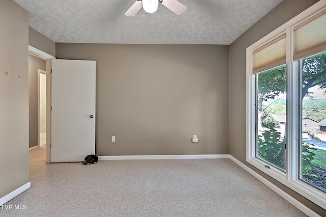 spare room with a textured ceiling and ceiling fan