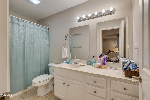 bathroom featuring toilet, a shower with curtain, vanity, and tile patterned floors