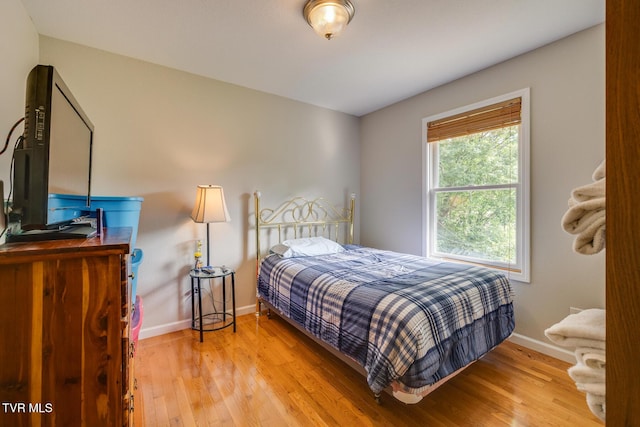 bedroom featuring light wood-type flooring and baseboards