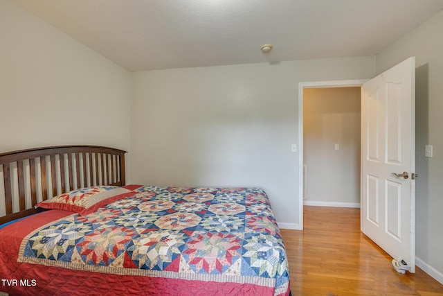 bedroom featuring light wood-style floors and baseboards