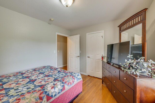 bedroom featuring light wood-type flooring and baseboards