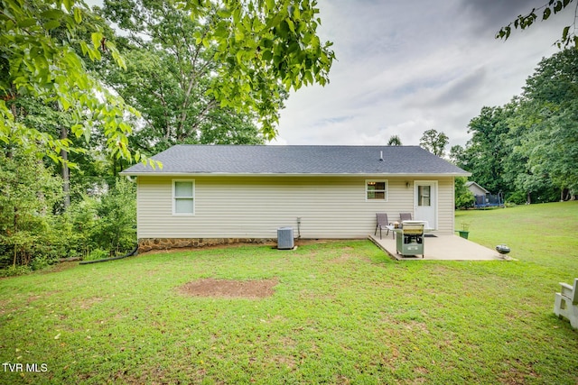 back of property featuring a patio, central AC unit, and a lawn