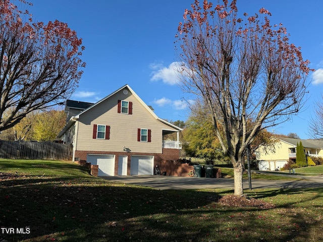 view of home's exterior with a lawn and a garage