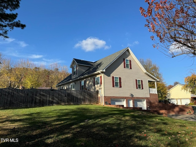 view of property exterior featuring a yard and a garage