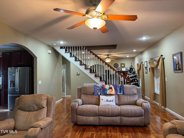 living room with hardwood / wood-style flooring and ceiling fan