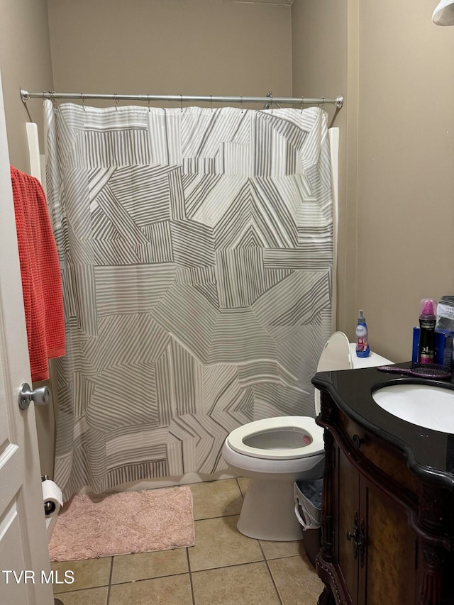 bathroom with tile patterned flooring, vanity, and toilet