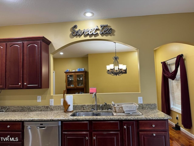 kitchen featuring kitchen peninsula, dark hardwood / wood-style flooring, sink, a notable chandelier, and dishwasher