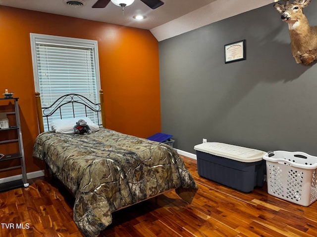 bedroom featuring dark hardwood / wood-style floors, ceiling fan, and vaulted ceiling