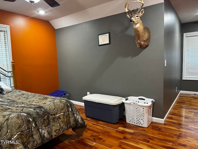 bedroom featuring dark hardwood / wood-style floors, ceiling fan, and lofted ceiling