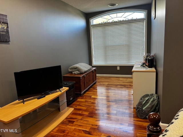 office area featuring a textured ceiling and dark wood-type flooring