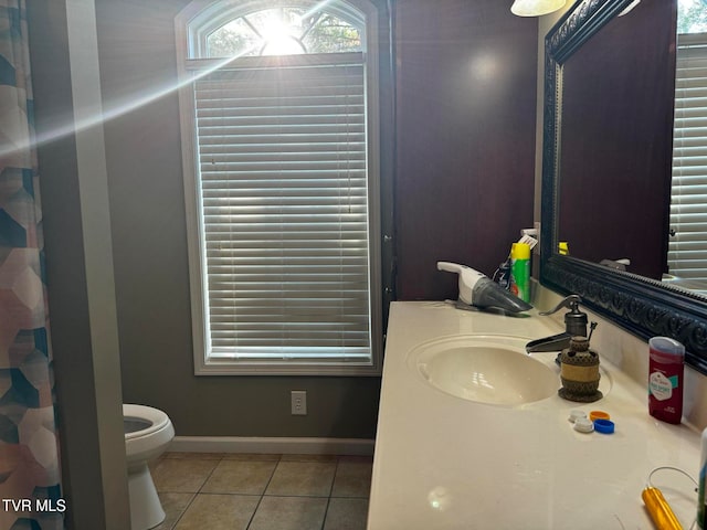 bathroom featuring tile patterned floors, a shower with curtain, toilet, and sink