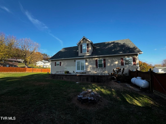 back of house featuring a lawn and a patio