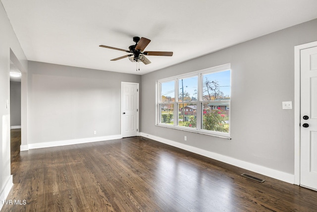 unfurnished room with ceiling fan and dark wood-type flooring