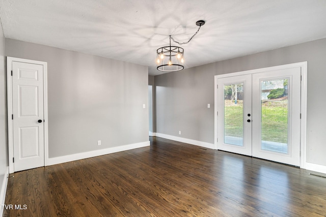 interior space with dark hardwood / wood-style flooring, french doors, and an inviting chandelier