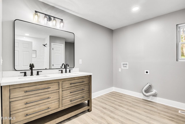 bathroom with a shower, hardwood / wood-style floors, and vanity