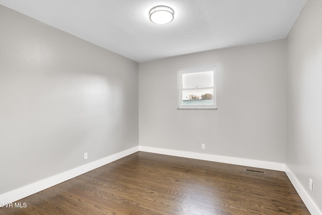 empty room featuring dark hardwood / wood-style flooring