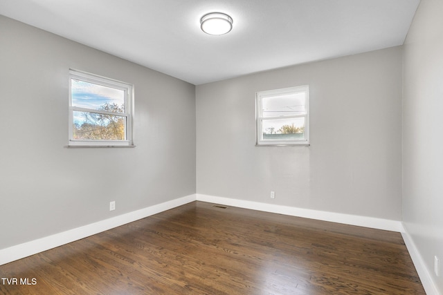 empty room featuring dark wood-type flooring