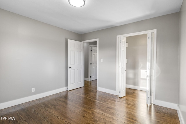 unfurnished bedroom with dark hardwood / wood-style floors