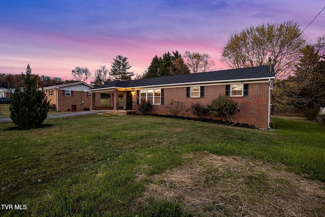 single story home with a lawn