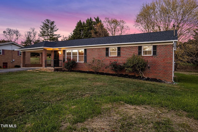 single story home with a carport and a lawn